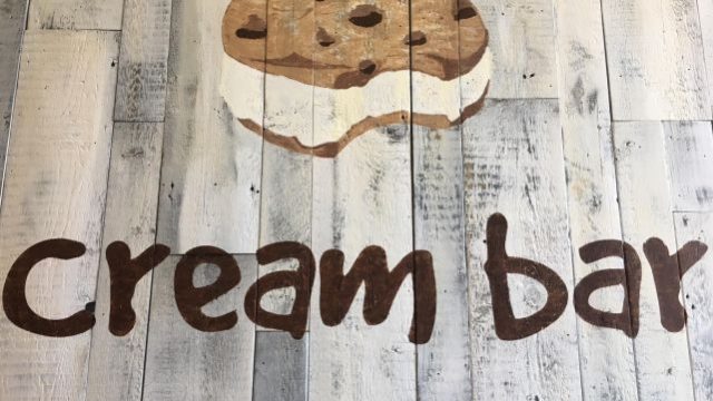 The logo on wood panelling in the store