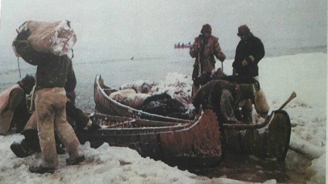 After chopping through ice, the team unloads and prepares to set up camp.