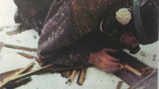 A crew member tries to build a fire.
