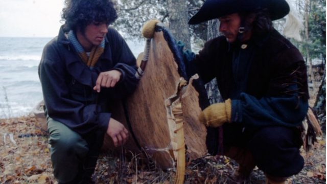 Richard Gross and Reid Lewis inspect a broken canoe.
