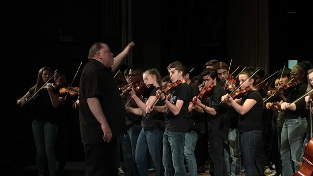 Barrage 8 Musical Director Dean Marshall directs the students as they play Mountain Spring.
