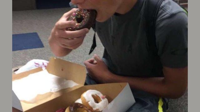 Graham shares and eats County Donuts with friends.