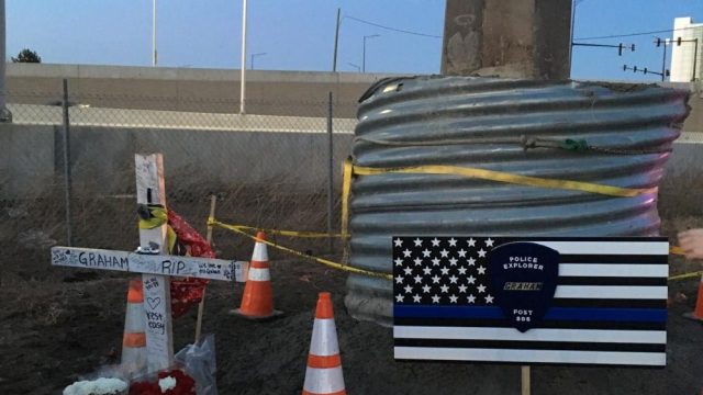 Friends and family of Graham’s lay flowers, posters and items at the crash site.