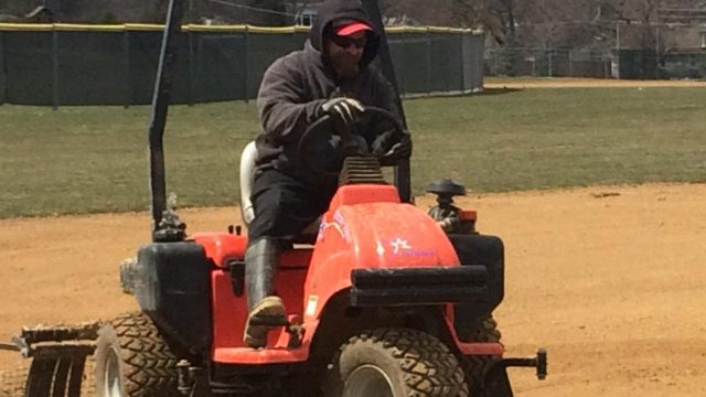 Groundsman Keith Strachn works on the lower level baseball field.