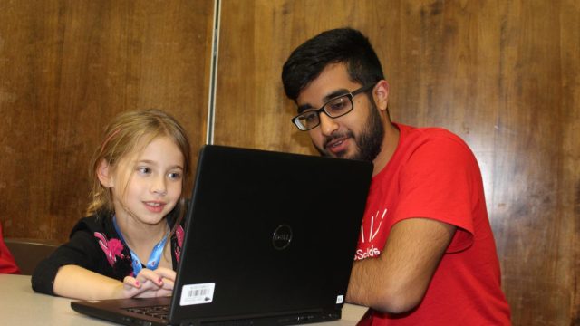 Darsh Dalal, '19, helps student understand an algorithm concept.