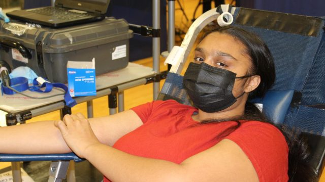Milli Patel, '23, smiles as she donates blood.